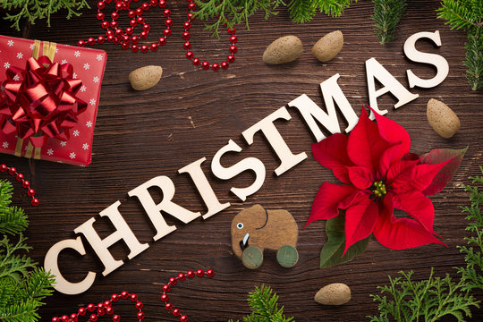 sweet decoration and the word "christmas" on wooden background