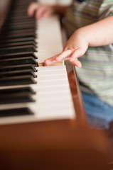 Fototapeta premium small hands playing piano keys