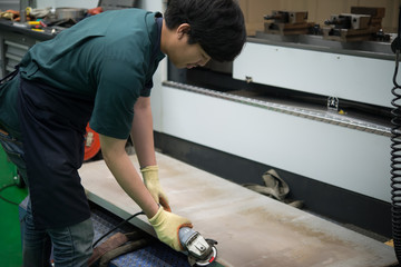 Mechanical engineer working at the plant of machine tools,Asian Lathe Technician at Work,Thailand people,Asian handsome industrial worker operating cnc machine