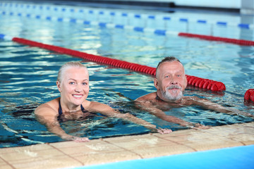 Sportive senior couple in indoor swimming pool