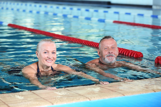 Sportive senior couple in indoor swimming pool
