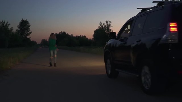 Blond girl unsuccessfully trying to stop car
