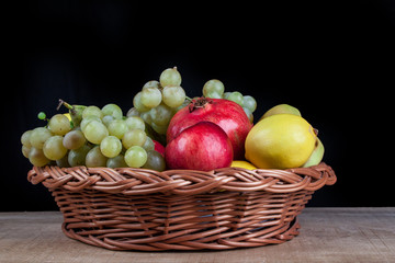 pomegranates and other fruit in the basket