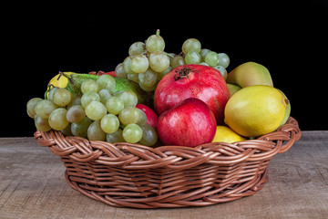 pomegranates and other fruit in the basket