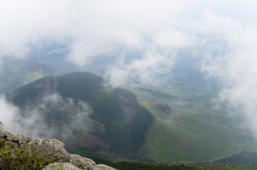 View from mountain to valley in Tatra mountains, Slovakia. Foggy morning.