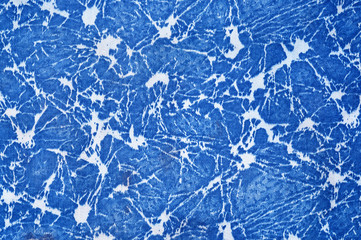 The fabric of blue color with an abstract white pattern