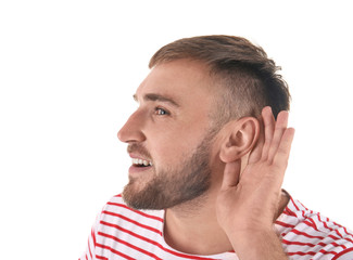 Obraz premium Young man with hearing problem on white background