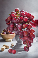 Red grape bunch and glass of wine. Still life concept - 221863143