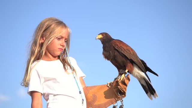 Blond girl blue eyes together hawk eagle.