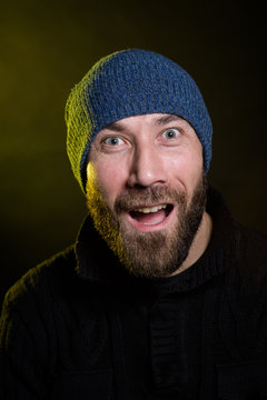studio portrait of cute young caucasian male in wool cap hat with emotions