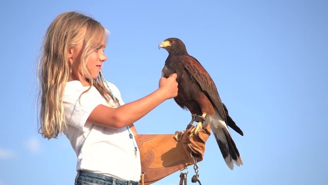 Blond girl blue eyes together hawk eagle.