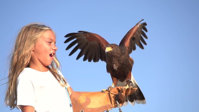 Blond girl blue eyes together hawk eagle.