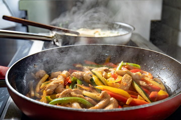 Vegetables and chicken prepared in frying pan