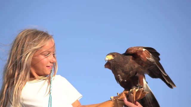Blond girl blue eyes together hawk eagle.