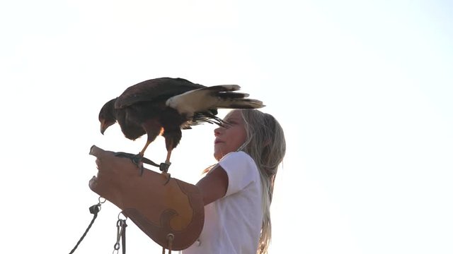 Blond girl blue eyes together hawk eagle.