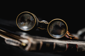 Ancient binoculars lie on book