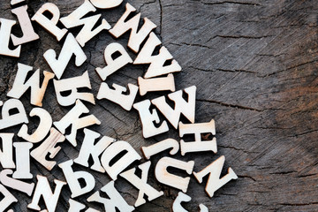 Abstract background of letters on an old wooden texture. Copy space for design.