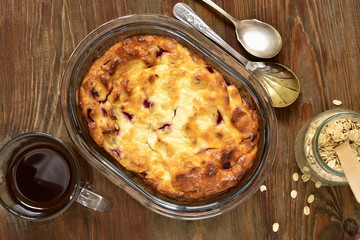 Cottage cheese pudding with oat flakes and red currant,  top view 