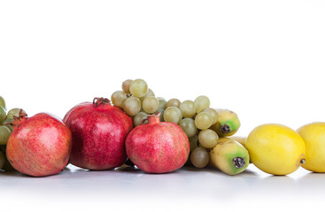 pomegranates and other fruits on a white background