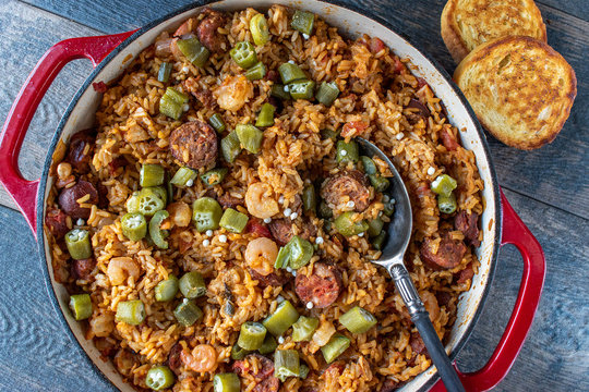 Baking Dish With Shrimp, Sausage, And Rice Jambalaya And Spoon