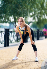 Woman in fit wear tired, during morning jogging