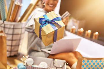 Adult woman at home wrapping Christmas presents