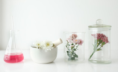 cosmetic skincare beauty product .natural organic flower oil ingredient in the laboratory. packaging spa concept.