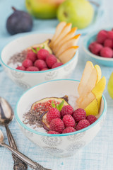 Smoothie bowl with fresh fruits, chia seeds, raspberry and fig