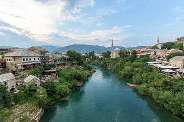 Fototapeta na wymiar Mostar seen from Stari Most Bosnia and Herzegovina, The Old Bridge in Mostar with emerald river Neretva.