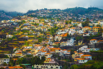 Fototapeta premium Houses with tiled roofs on the mountainside.