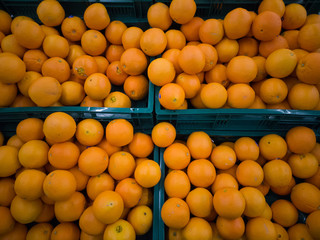 Some oranges in a basket at supermarket.