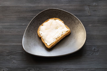 sandwich with buttered butter on black plate