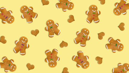 Christmas cookies and hearts on yellow background.