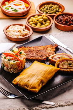 Christmas dish in Venezuela, hallaca, ham bread, salad and pork