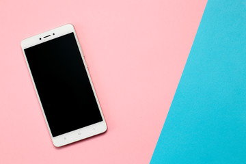 Smartphone with blank screen on pink background.