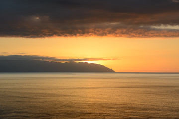 Sunset in the clouds over Gomera Island, Tenerife, Canary, Spain.