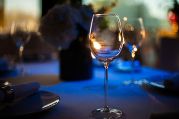 Seeved table in restaurant with wineglasses.