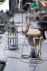 Djembe, a drum from West Africa, on stage with amplifying equipment before the concert
