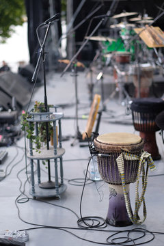 Djembe, a drum from West Africa, on stage with amplifying equipment before the concert