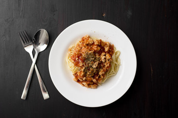 Spaghetti on black wooden background