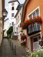Beautiful German street view with the building of the church bell tower at the far end, Neuerburg, Rhineland-Palatinate