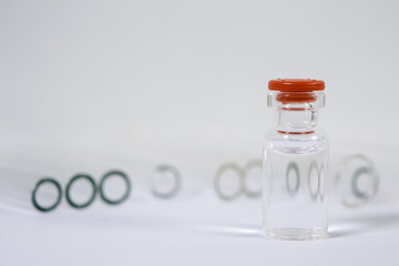 Group of vials with medication on blue methacrylate table.