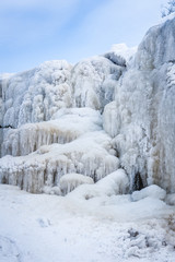 Fototapeta na wymiar Frozen cascade of waterfall. Winter background. Jagala Waterfall, Estonia. Soft focus.