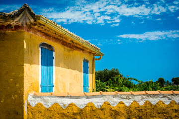 Blue-yellow village Greek cottage