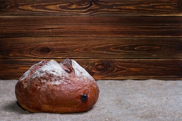 Still-life with fresh bread on sackcloth with space for text, selective focus