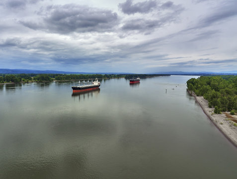 Drone Aerial of 2 cargo ships on the Columbia River on a cloudy summer day