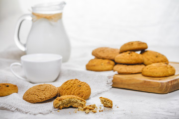 Fresh delicious oatmeal cookies and milk for breakfast, selective focus, close-up