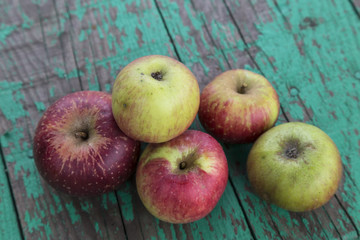 natural and organic apples on the green wooden table at the garden for kitchen concept.