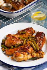 Baked chicken legs with peas, beans and fresh herbs. Chicken drumsticks with tasty sause and greens