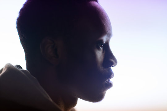Profile of a man with hoodie on a light background